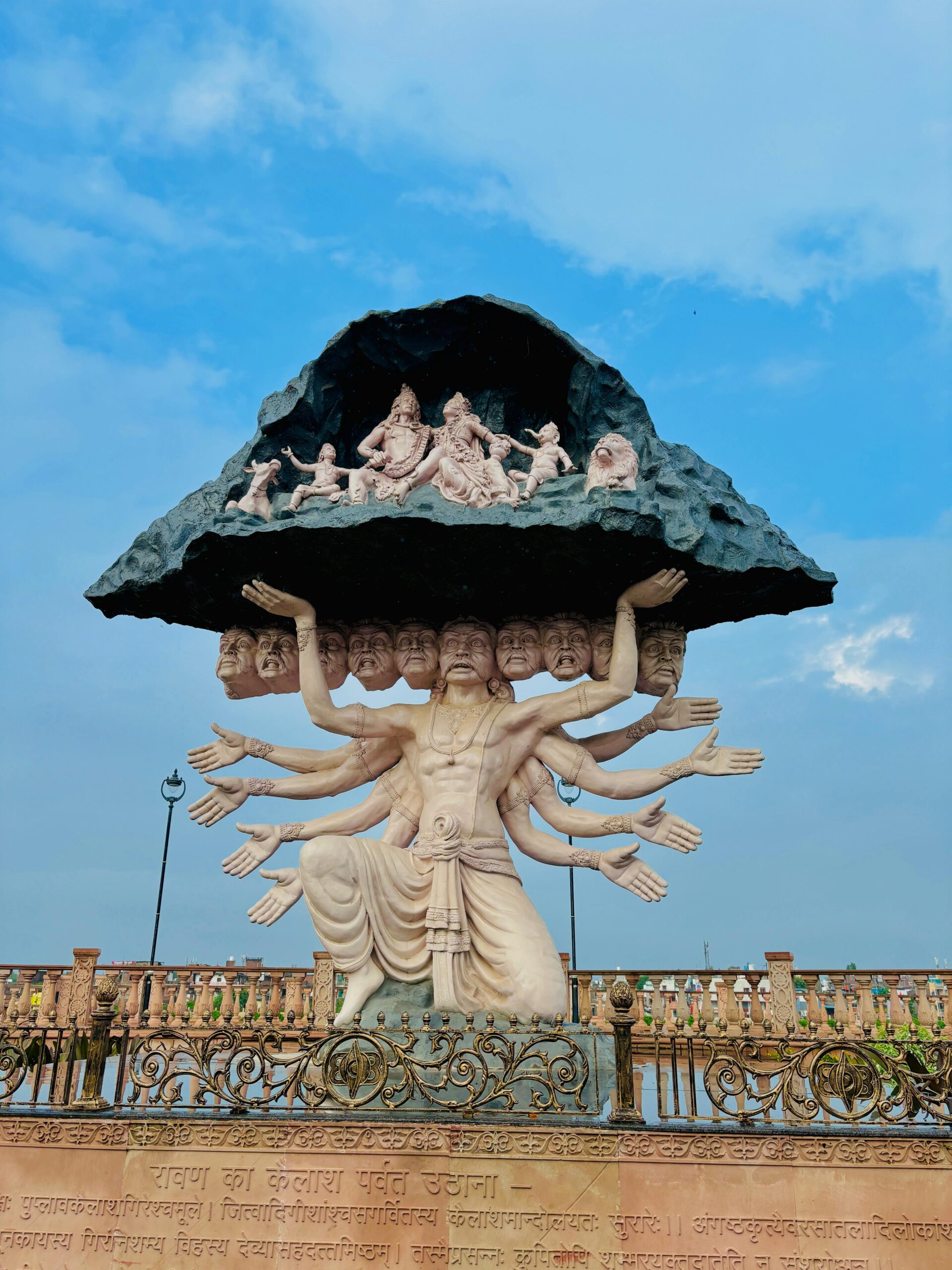Statue of Ravan lifting Kailash mountain with deities in Ujjain, India.