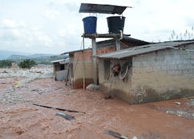 Severe flood damage in Mocoa, Colombia with buildings partially submerged in mudflow, Water Crisis