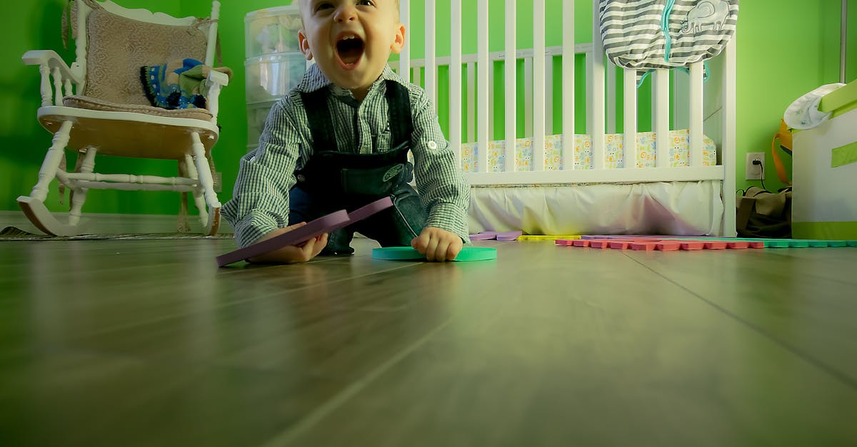Delightful baby boy crawling on a wooden floor, playing happily in a vibrant green nursery, Children played games on Heart Day,child kidnapping